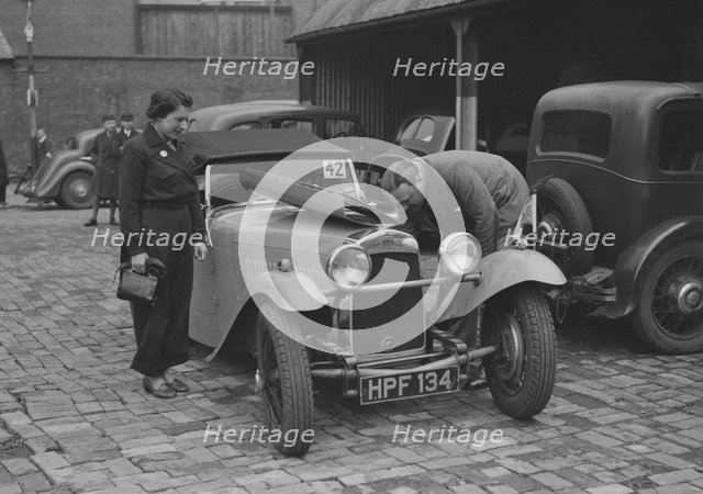 AES Curtis looking under the bonnet of his HRG at the RAC Rally, 1939. Artist: Bill Brunell.
