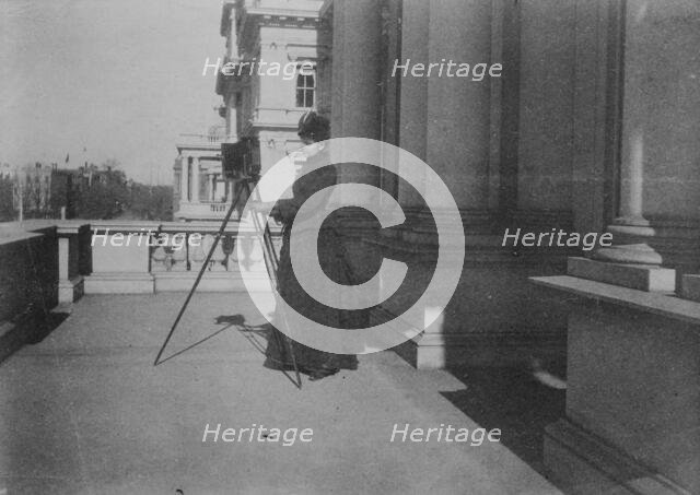 Frances Benjamin Johnston with camera on balcony of State, War and Navy Building..., 1888. Creator: Frances Benjamin Johnston.