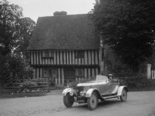 Two women in a AC motor car in front of a Tudor house, c1930s Artist: Bill Brunell.