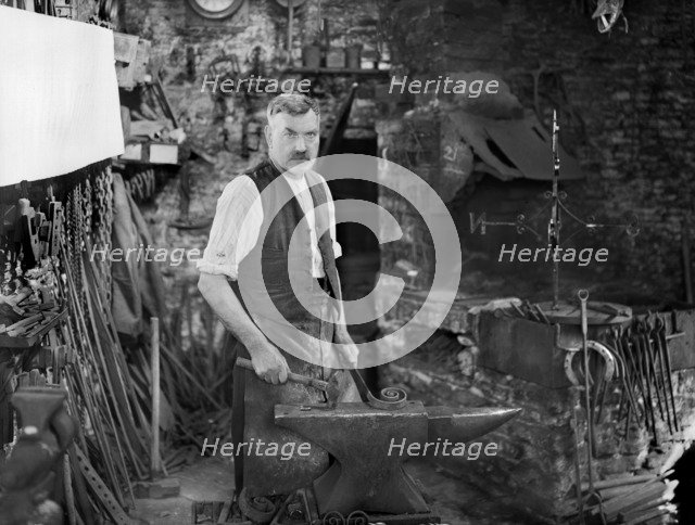 Mr Jefferies at work in the forge, Southrop, Cotswolds, Gloucestershire, 1938. Creator: Sydney Alfred Pitcher.