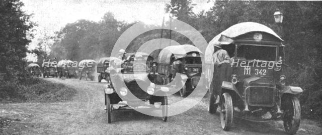 'Au Volant; convoi d'autos-camions menes par des conducteurs indo-chinois, sous..., 1918. Creator: Unknown.