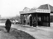 1923 10 hp Calcott arriving at a petrol station, (c1923?). Artist: Unknown