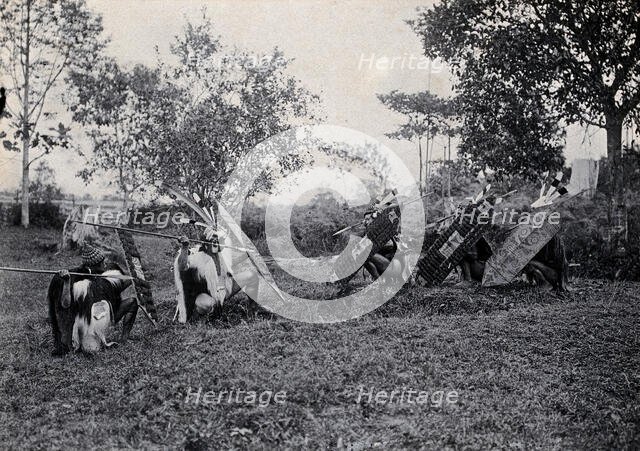 Sarawak: five Kenyah warriors in a warfare ritual, c1900. Creator: Unknown.