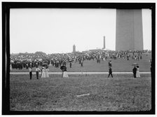 Crowd at base of Washington Monument, Washington, D.C., between 1909 and 1923. Creator: Harris & Ewing.