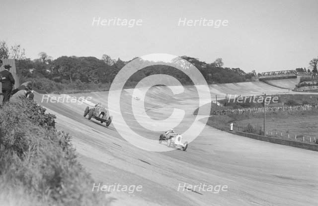 Sir Henry Birkin's Bentley racing RJ Munday's Vauxhall 30/98, BARC meeting, Brooklands, 16 May 1932. Artist: Bill Brunell.
