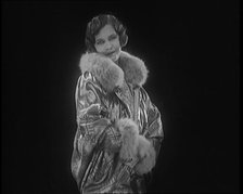 Female Civilian Modelling a Glamorous Fur Trimmed Coat, 1920. Creator: British Pathe Ltd.