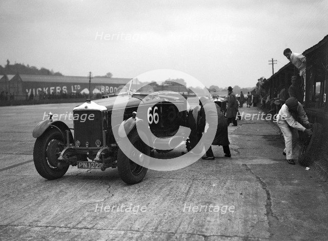 GL Baker's 5954 cc Minerva undergoing a rear wheel change at Brooklands. Artist: Bill Brunell.