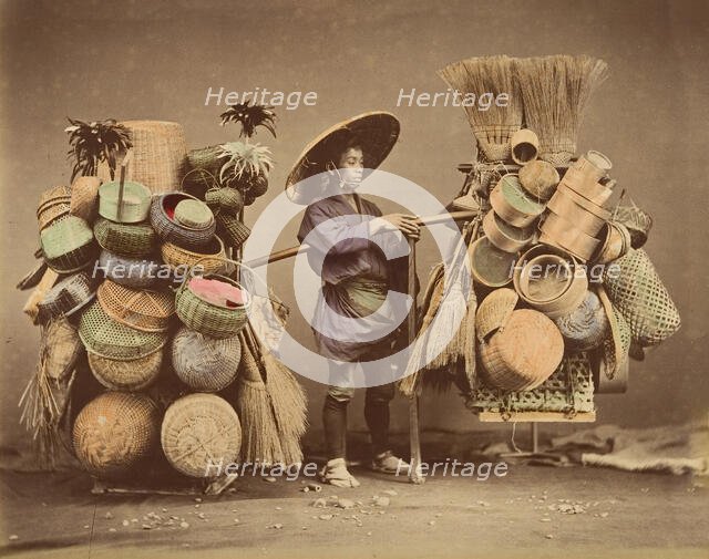 [Japanese Man Posing with Baskets, Brooms and Feather Dusters], 1870s. Creator: Unknown.