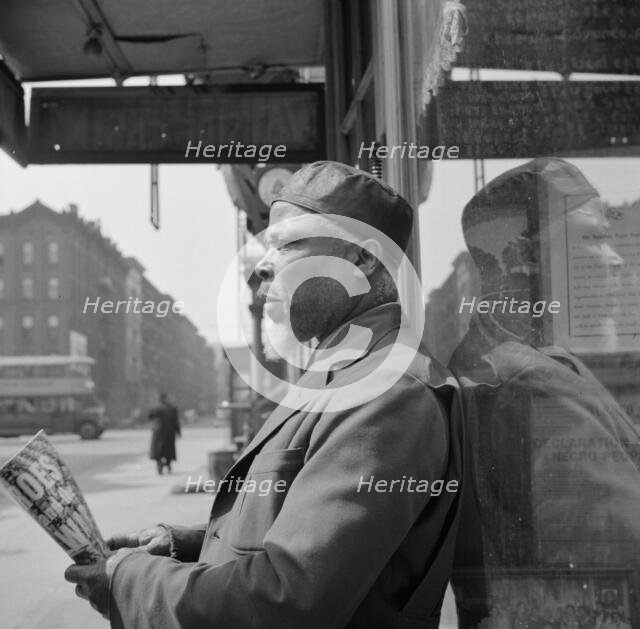 A follower of the late Marcus Garvey who started the "Back to Africa" movement, New York, 1943. Creator: Gordon Parks.