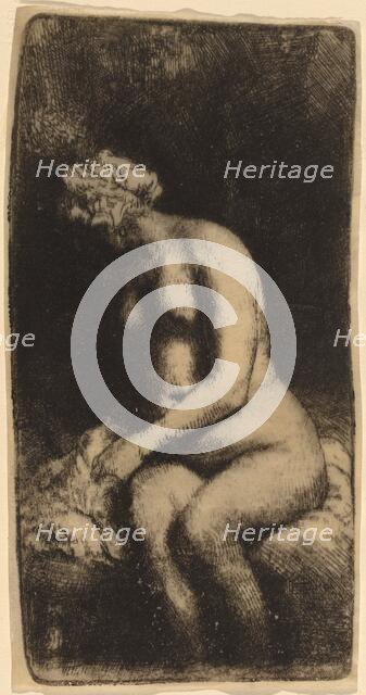 Nude Seated on a Bench with a Pillow (Woman Bathing Her Feet at a Brook), 1658. Creator: Rembrandt Harmensz van Rijn.