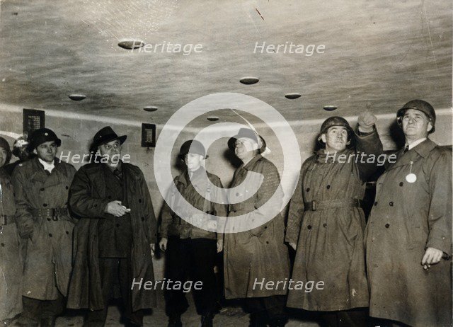 American soldiers examine a gas chamber, Dachau concentration camp, Bavaria, Germany, c1945. Artist: Unknown