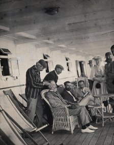 Members of the British Association playing at phrenology on board a ship on its way to..., 1905. Creator: James Thomson Bottomley.