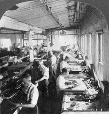 Workers cutting leather for shoes in a factory, Lynn, Massachusetts, USA, 20th century. Artist: Keystone View Company