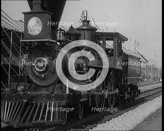 Old Locomotive Travelling Along the Tracks in Front of an Audience of Civilians in a Show..., 1920s. Creator: British Pathe Ltd.