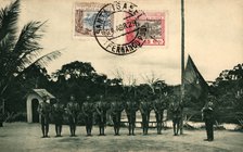 Postcard. St. Elizabeth of Fernando Poo. Flag hoisting by the colonial guard at the Assobla post,…