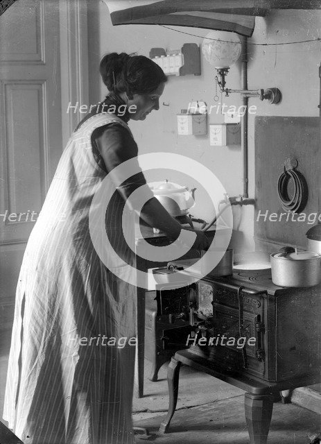 The photographer's wife in the kitchen, Landskrona, Sweden, 1910. Artist: Unknown