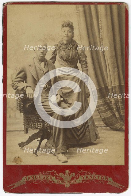 Photograph of African-American man and woman in formal clothes, late 19th century. Creator: Louis Janousek.