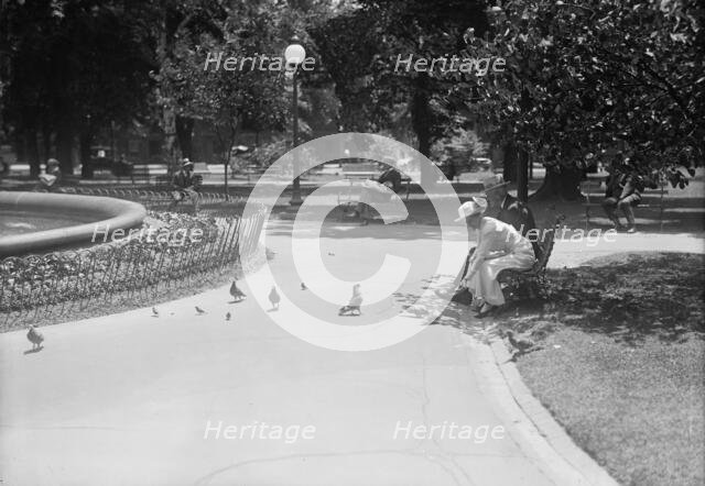 District of Columbia Parks - Feeding Pigeons in The Parks, 1917. Creator: Harris & Ewing.