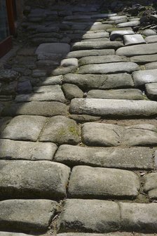 Remains of a Roman road next to the Valmardon Gate, paved with granite slabs, Toledo, Spain, 2022.  Creator: LTL.