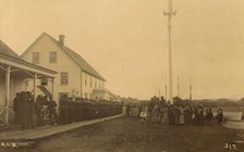 Sailors standing in line on boardwalk with a group of local women and men standing..., 1894 or 1895. Creator: Alfred Lee Broadbent.