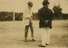 Two men, probably journalists, standing on a field, 1905. Creator: Unknown.