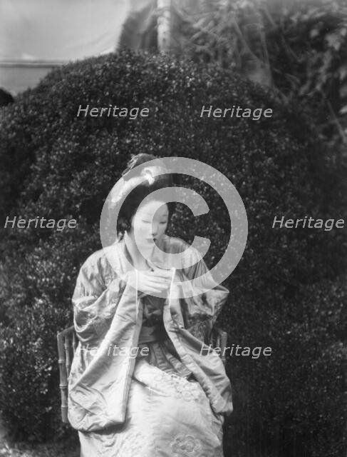 Person wearing a mask made by W.T. Benda, 1925 Sept. 20. Creator: Arnold Genthe.