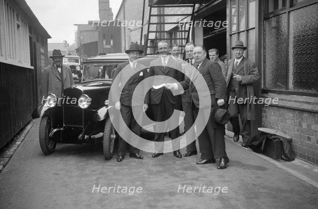 Group of men with a Triumph Super Seven, c1930(?). Artist: Bill Brunell.