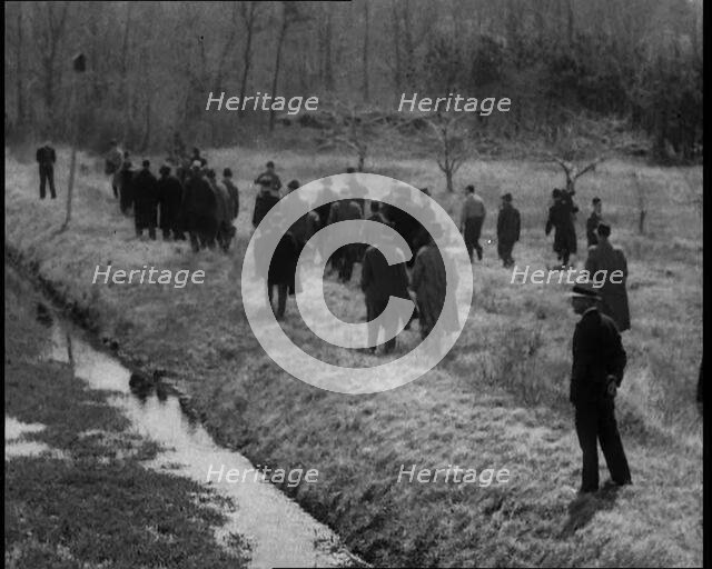 American Police Officers Searching the Area Outside American Aviator Charles Augustus..., 1930s. Creator: British Pathe Ltd.