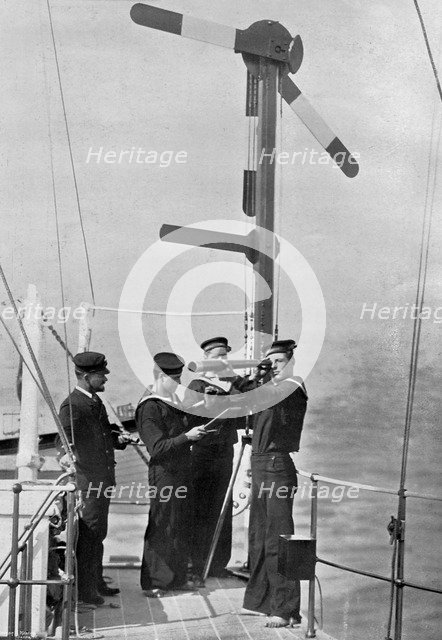 Signalling by semaphore on board HMS 'Camperdown', 1895. Artist: Gregory & Co