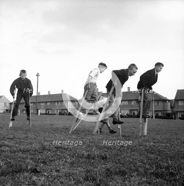 Children walking on stilts, c1955. Creator: Arthur Charles Kirby Ware.