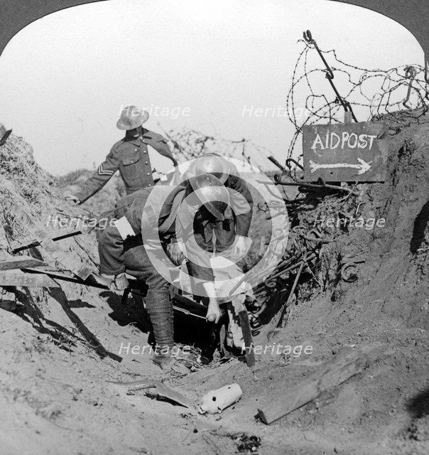 Carrying a wounded soldier to a first aid post, Passchendaele, Belgium, World War I, 1914-1918.Artist: Realistic Travels Publishers