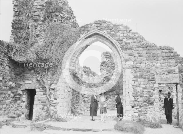 Three women and a man standing in front of ruins, between 1911 and 1942. Creator: Arnold Genthe.