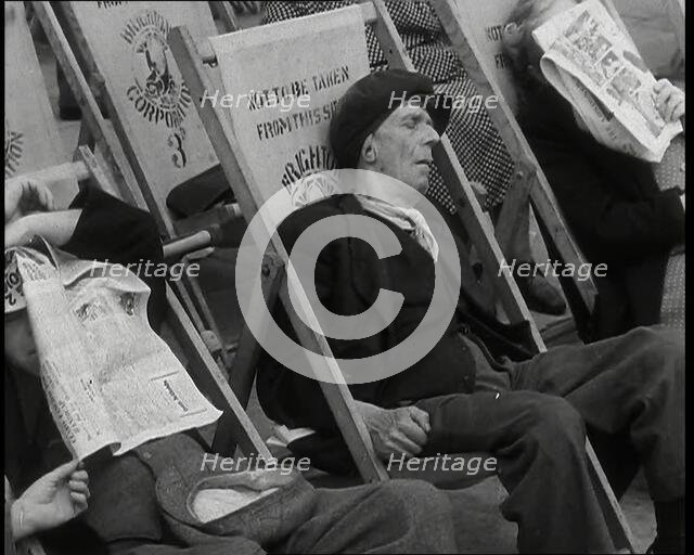 Close up on a Man in a Flat Cap and With a Neckerchief Sleeping in a Deck Chair on the Prom..., 1938 Creator: British Pathe Ltd.