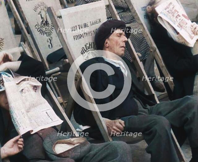 Close up on a Man in a Flat Cap and With a Neckerchief Sleeping in a Deck Chair on the Prom..., 1938 Creator: British Pathe Ltd.