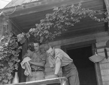 Hop farmer's sons, washing for noon meal on back porch, Independence, Polk County, Oregon, 1939. Creator: Dorothea Lange.