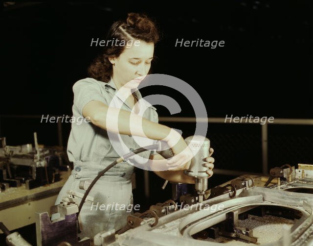 Drilling a wing bulkhead for a transport plane at the Consolidated Air..., Fort Worth, Texas, 1942. Creator: Howard Hollem.