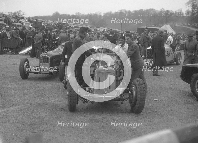 Dick Seaman's ERA, Dick Shuttleworth's Alfa Romeo and a MG Magnette at Donington Park, 1935. Artist: Bill Brunell.