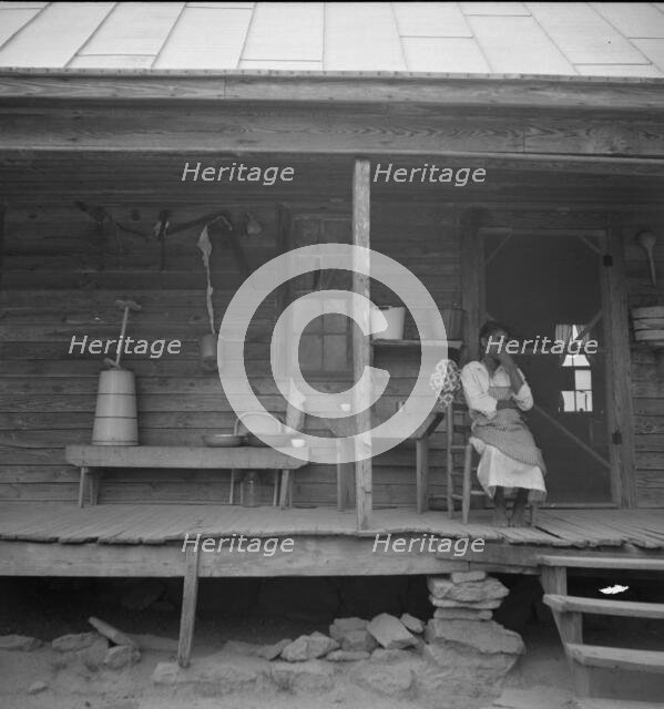 Porch of Negro tenant house, showing household equipment, Person County, North Carolina, 1939. Creator: Dorothea Lange.