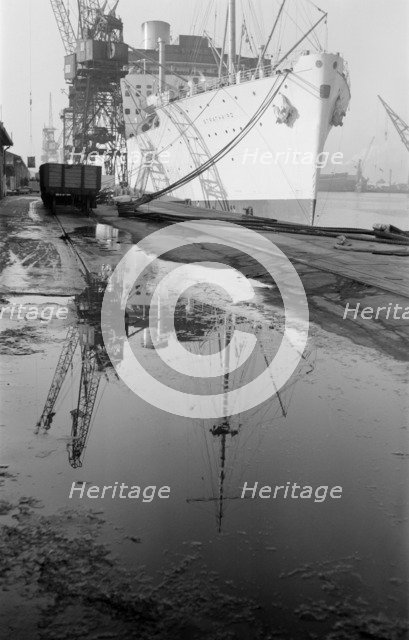 The 'Strathaird' reflected in a puddle at Tilbury Docks, Essex, c1945-c1965. Artist: SW Rawlings