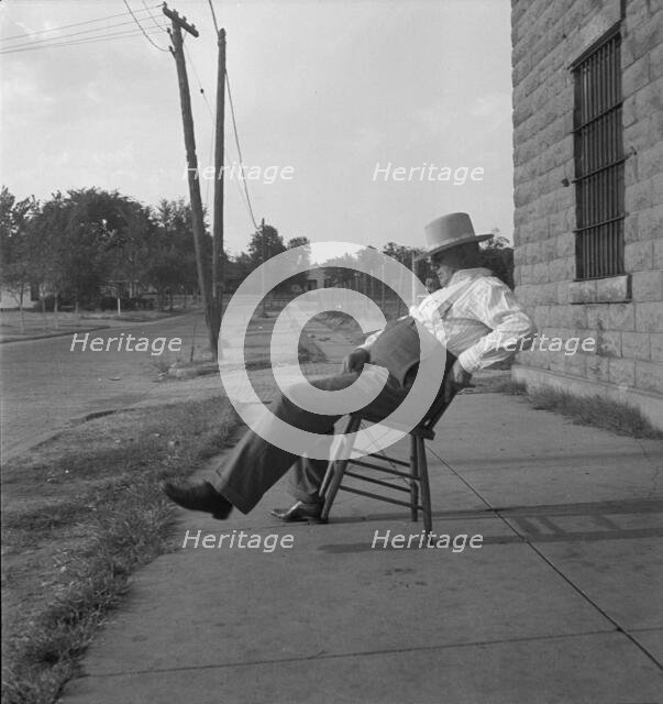 The sheriff of McAlester, Oklahoma, sitting in front of the jail, 1936. Creator: Dorothea Lange.