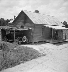 Home of Negro tobacco tenant with addition of improvised garage, Wake County, North Carolina, 1939. Creator: Dorothea Lange.