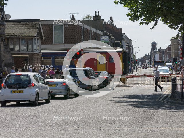 Train passing through level crossing in Lincoln 2014 Artist: Unknown.