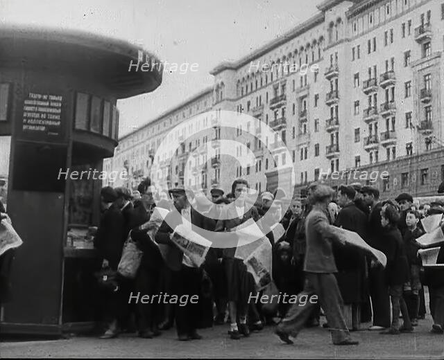 Civilians with newspapers in the Streets of Moscow, 1941.  Creator: British Pathe Ltd.