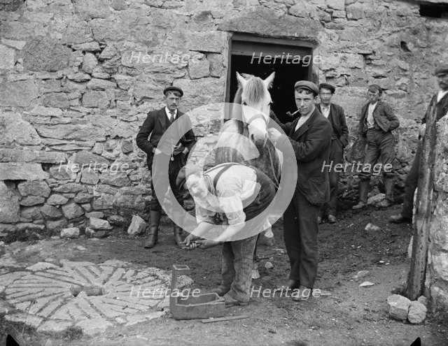 A smith in Fore Street, St Just, Cornwall, 1901. Artist: A Newton