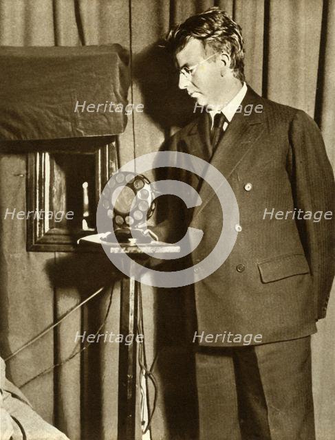 John Logie Baird watching the first play to be televised, 14 July 1930, (1935). Creator: Unknown.