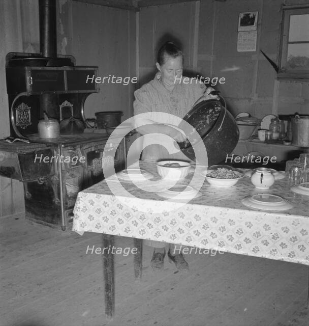 Mrs. Wardlow getting dinner after church in her basement..., Dead Ox Flat, Oregon, 1939. Creator: Dorothea Lange.