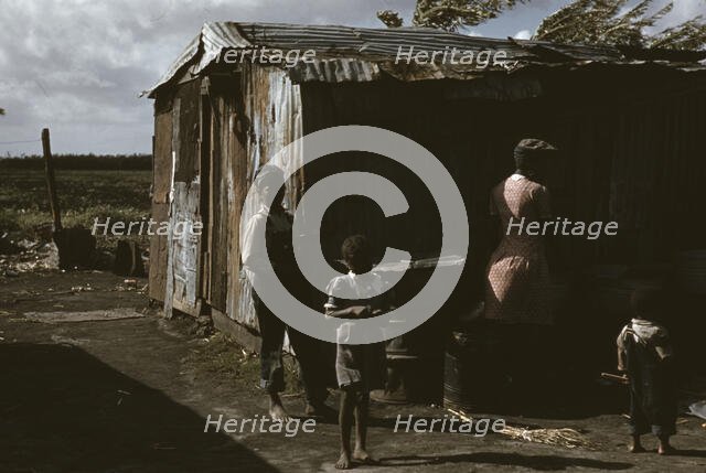 Negro migratory workers by a shack, Belle Glade, Fla., 1941. Creator: Marion Post Wolcott.