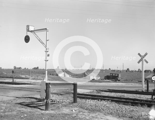 Migrants' tents..., along the right of way of the Southern Pacific, Near Fresno, California, 1939. Creator: Dorothea Lange.