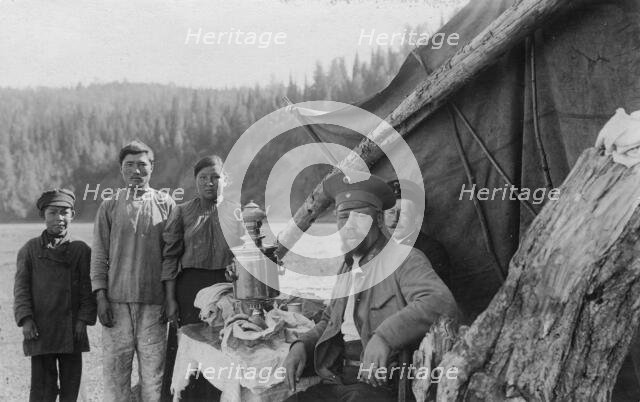 G.I. Ivanov and a Shoria Family at the Table with Samovar Near the Tent, 1913. Creator: GI Ivanov.