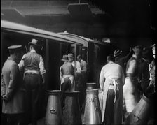 Volunteer Male Civilians Lifting Milk Churns and Helping Deliver Milk, 1926. Creator: British Pathe Ltd.